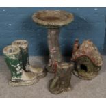 A quantity of concrete garden ornaments. Includes bird bath, mushroom cottage, pair of wellington