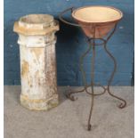 A wrought iron wash stand with pancheon along with a chimney pot.