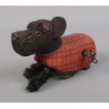 A Schuco wind up Scottish Highland Terrier with key. Missing one ear but in working order.