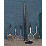 A cased snooker cue along with a collection of vintage tennis and badminton rackets. Includes