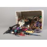 A large collection of assorted costume jewellery to include necklaces, bracelets, etc.