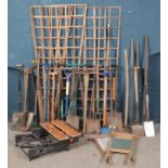 A large quantity of garden tools. Includes shovels, hoes, pitchforks, hedge cutters,