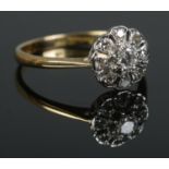 A mid twentieth century 18ct Gold and Platinum Diamond cluster ring, with central brilliant cut