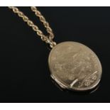 A 9ct gold locket on 9ct gold chain. Locket decorated with birds and chain stamped Italy. 11.79g.