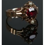 A nineteenth century ring set with central garnet and pearls. Tests to 9ct Gold. Size K. Total
