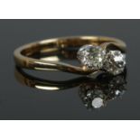 An 18ct Gold two stone diamond ring; Old European cut, with each stone approximately 1/4ct (4mm x