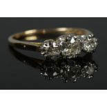 An 18ct Gold and Platinum three stone diamond ring. Largest stone over Â¼ct, with a diameter of 5mm.