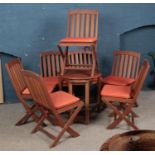 A set of garden furniture including table and seven folding chairs.