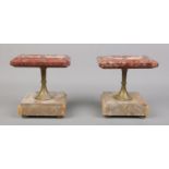 Two marble stands with turned central metal stems, raised on four small turned feet. Chip to the top