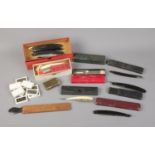 A collection of men's shaving accessories including quantity of cut throat razors.