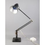 A black Herbert Terry angle-poise lamp, on stepped square base. Wiring has been altered, to run