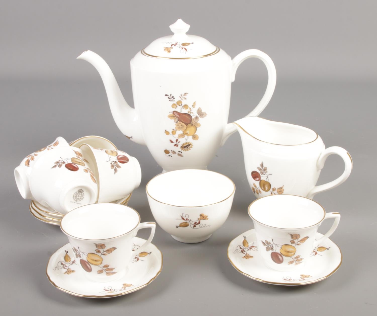 A Royal Worcester coffee set decorated in the Golden Harvest pattern.