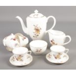 A Royal Worcester coffee set decorated in the Golden Harvest pattern.