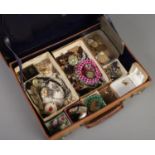 A small leather case with contents of vintage costume jewellery and coins. Includes pheasant foot