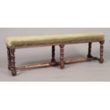 A Victorian mahogany upholstered double stool with barley twist supports. Height 38cm, Length 115cm,