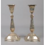 A pair of George V silver candlesticks with detachable nozzles. Assayed Sheffield 1922 by Cooper