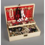 A cantilever jewellery box with contents of assorted costume jewellery including necklaces, rings,