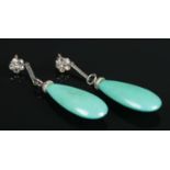 A pair of white metal, diamond and turquoise drop earrings. Size of stone (with white metal mount)