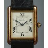 A Must De Cartier silver gilt tank watch, model 2413. Having date display, Roman numeral markers and