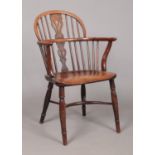 A 19th century ash/elm and yew wood Windsor arm chair with crinoline stretcher. Height of back 88cm,