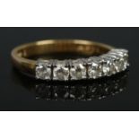 An 18ct gold seven stone diamond ring. Size M 1/2. 3.56g. Approximately diamond 0.75ct in total.