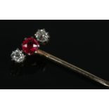 A Victorian yellow metal, diamond and ruby coloured stone stick pin.
