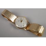 A gents 9ct gold Longines manual wristwatch on stainless steel bracelet strap. Having baton and