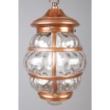 A hanging copper mounted lantern with bubble effect glass panels. With wall mounted hook fixture.