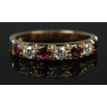 An 18ct gold diamond and ruby seven stone ring. Assayed for Sheffield 1981, makers mark J&P. Size N.