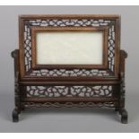 A Chinese Qing dynasty carved hardwood and white jade table screen. The panel carved in relief