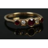 An 18ct ruby and diamond five stone ring. Size P 1/2. 2.52g.