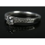 A platinum and diamond ring. The central stone (approximately 0.36ct) flanked by six stones to