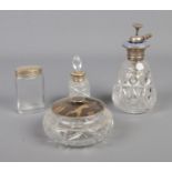 Four glass vanity items. To include a silver lidded bowl, a Silver collared scent bottle and an