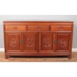 A Chinese carved hardwood sideboard. Height 86.5cm, Width 153cm, Depth 48.5cm.