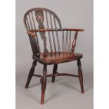 A 19th century ash/elm and yew wood Windsor arm chair with crinoline stretcher. Height of back 86cm,