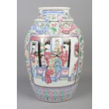 A late 19th/early 20th century Chinese famille rose vase. Decorated with panels depicting figures