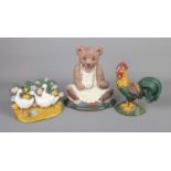 Three cast iron doorstops in the form of a Rooster, group of Geese and Teddy Bear.