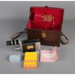 A Bell & Howell 16mm Cine Camera in original leather carry case with accessories such as manual