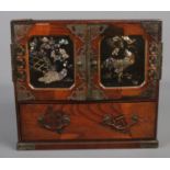 A Chinese wooden jewellery box with marquetry and abalone shell inlay. Metal bound doors and