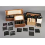 Four cases of Magic Lantern Slides depicting an assortment of photographs with subjects including