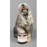 A large Beswick Dulux advertising figure of an old English sheep dog with paw raised on a tin of