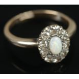 An 18ct gold opal and diamond ring. Central opal surrounded by ten diamonds. Size N, 3.68g.