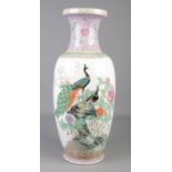 A large 20th century Chinese famille rose floor vase decorated with peacocks and chrysanthemums.