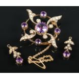 A 9ct gold amethyst & seed pearl jewellery suite. Comprising of brooch and two earrings. 6.02g gross