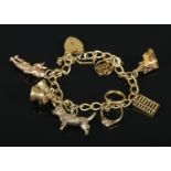 A 9ct gold charm bracelet with 9ct gold and 14ct gold charms. 32.07g. 14ct gold charms include