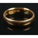 A 22ct gold wedding band. Size O, 3.85g.