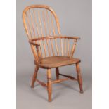 A 19th century ash/elm Windsor arm chair with spindle back. Height of back 97cm, Front seat width