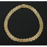 An 18ct gold panther link collar necklace. Length approximately 43cm. 107.71g. Stamped 750 to clasp.