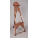 A large easel with extensively carved floral decoration. Height 180cm.