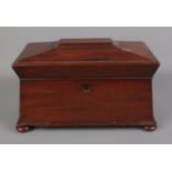 A mahogany sarcophagus form tea caddy. Missing interior.